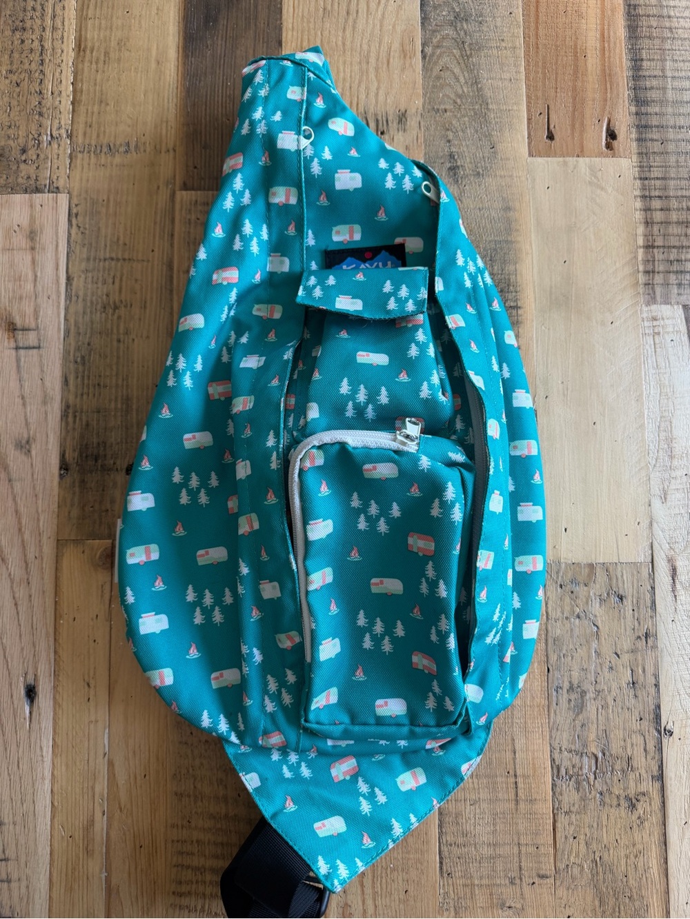 Teal Kavu Rope Sling Bag camper and pine trees campfire
